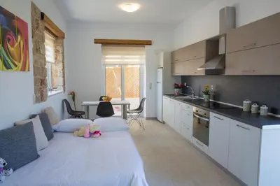 a kitchen with a large bed in a room at G&K Stone Suites in Haraki