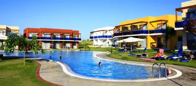 a swimming pool in a resort with people in it at All Senses Nautica Blue Exclusive Resort & Spa - All Inclusive in Phanaes