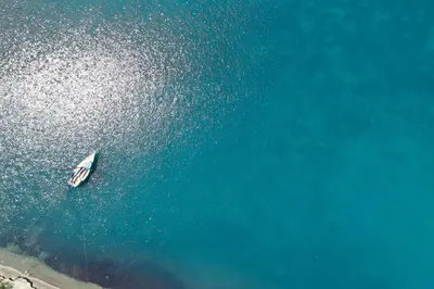 an aerial view of a boat in the ocean at All Senses Nautica Blue Exclusive Resort & Spa - All Inclusive in Phanaes
