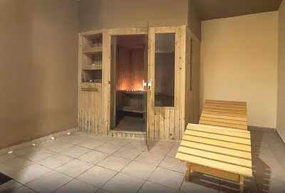 a room with a bench in the corner of a room at All Senses Nautica Blue Exclusive Resort & Spa - All Inclusive in Phanaes