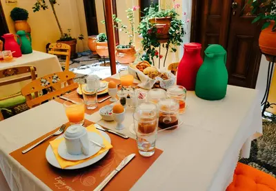 a table topped with plates and glasses of orange juice at Rodos Niohori Elite Suites Boutique Hotel in Rhodes Town