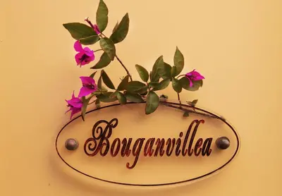 a sign with flowers on it on a wall at Rodos Niohori Elite Suites Boutique Hotel in Rhodes Town