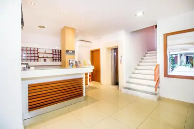 a kitchen with a staircase in a house at Filmar Hotel, Ixia, Rhodes in Ixia