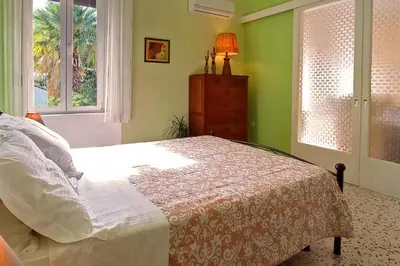 a bedroom with a bed and a window and a dresser at Italian flair with a view in Rhodes Town