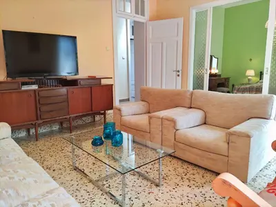 a living room with a couch and a tv at Italian flair with a view in Rhodes Town