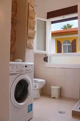 a bathroom with a washing machine and a window at Italian flair with a view in Rhodes Town