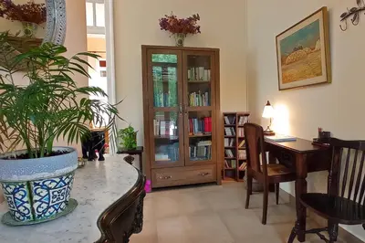 a living room with a table and a plant at Italian flair with a view in Rhodes Town