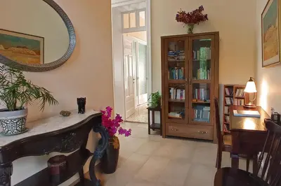 a living room with a table and a mirror at Italian flair with a view in Rhodes Town