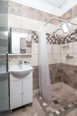 a bathroom with a sink and a shower at Toulas Studios & Apts No2 in Faliraki