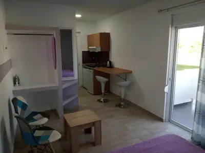 a small kitchen with a table and chairs in a room at Toulas Studios & Apts No2 in Faliraki