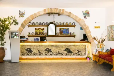 an archway in a room with a couch at Ekaterini Hotel in Kiotari
