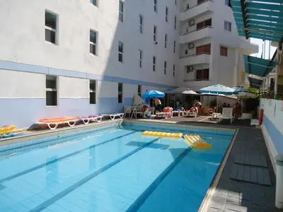 a large swimming pool in front of a building at Helena Hotel in Rhodes Town