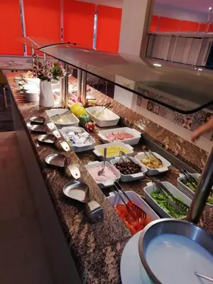 a buffet line with a lot of food at Helena Hotel in Rhodes Town