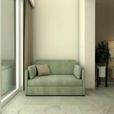 a green couch with a pillow in a room at Artemis Comfort&Pleasure in Faliraki