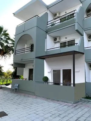 a white building with balconies on the side of it at Artemis Comfort&Pleasure in Faliraki