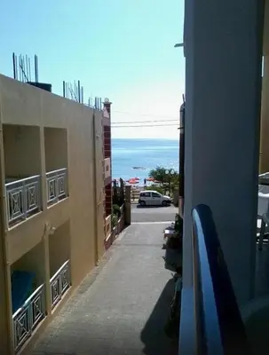 a building with a view of the ocean from a balcony at Stegna Star Apartments in Archangelos