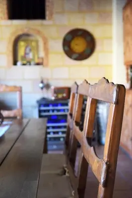a wooden chair sitting in a room with a table at Paris Hotel in Rhodes Town