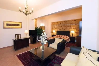 a living room with a couch and a table at Paris Hotel in Rhodes Town