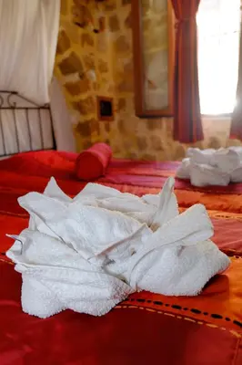 a pile of white towels sitting on top of two beds at Cava d'Oro in Rhodes Town