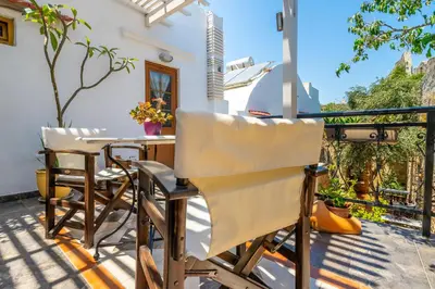 a patio with chairs and a table on a balcony at Cava d'Oro in Rhodes Town
