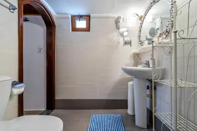 a bathroom with a sink and a toilet at Cava d'Oro in Rhodes Town