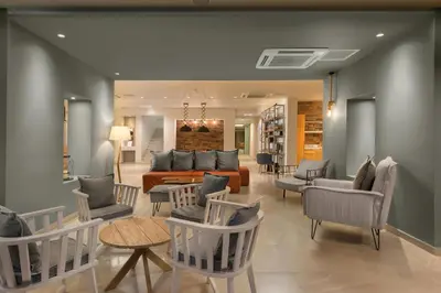 a living room with a couch and chairs at Matoula Beach in Ialyssos
