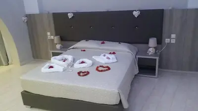 a bedroom with a bed with towels on it at Saint George Resort in Archangelos