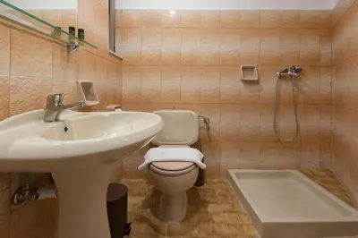 a bathroom with a sink and a toilet and a shower at Saint George Resort in Archangelos
