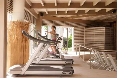 a woman on a treadmill in a gym at Esperos Palace Resort & Spa in Faliraki