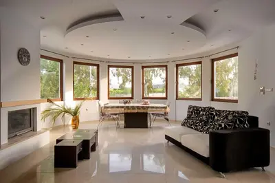 a living room with a couch and a table at Maia Luxury Pool Villa in Afantou