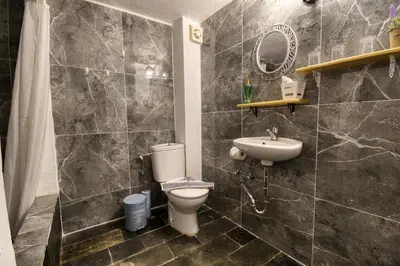 a bathroom with a toilet and a sink at Mascot Boutique Hotel in Rhodes Town