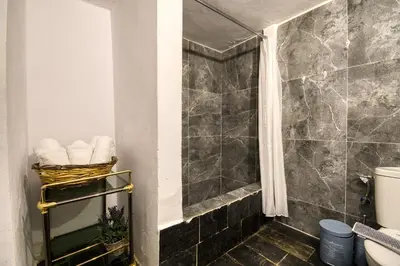 a bathroom with a shower with a sink and a toilet at Mascot Boutique Hotel in Rhodes Town
