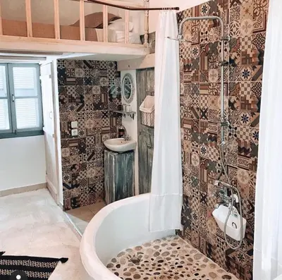 a bathroom with a tub and a sink at Mascot Boutique Hotel in Rhodes Town