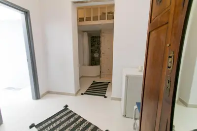 a hallway with a door and a room with black and white mats at Mascot Boutique Hotel in Rhodes Town