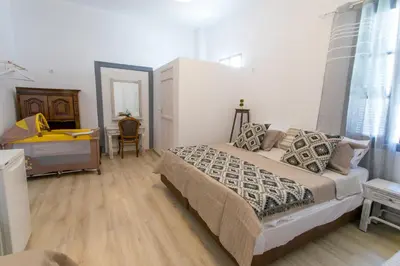 a bedroom with a bed and a dresser and a mirror at Mascot Boutique Hotel in Rhodes Town