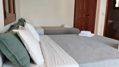 a bed in a room with two pillows on it at Maria Apartments in Pefki Rhodes