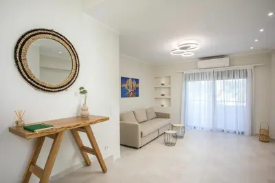 a living room with a table and a couch at Beachfront Villa SeaShell Superior in Gennadi