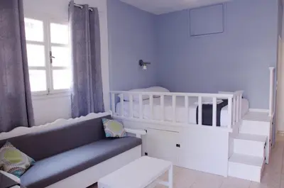 a baby room with a crib and a white crib at Amaradios in Rhodes Town