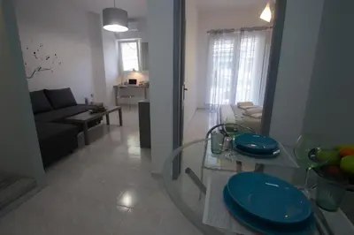 a living room with a couch and a table with blue plates at Amaradios in Rhodes Town