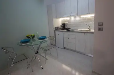 a kitchen with a table and chairs and a sink at Amaradios in Rhodes Town