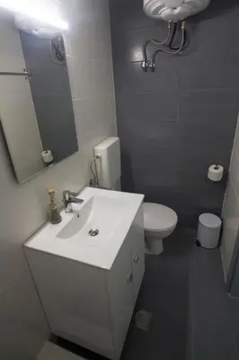 a bathroom with a sink and a toilet and a mirror at Amaradios in Rhodes Town
