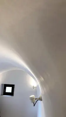 a light on a white wall with a light fixture at Villetta Erato-picturesque studio in Halki