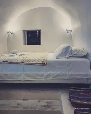a large bed in a room with a window at Villetta Erato-picturesque studio in Halki