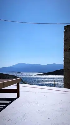 a bench sitting next to a body of water at Villetta Erato-picturesque studio in Halki