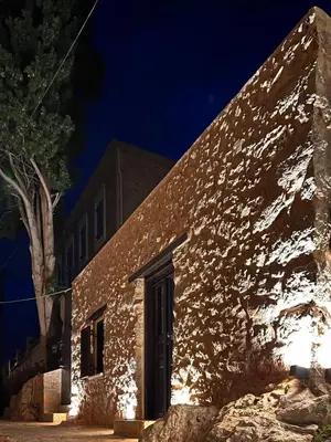 an old stone building at night with a tree at Villetta Erato-picturesque studio in Halki