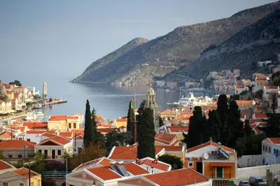 a view of a town next to the water at Eos Studios in Symi