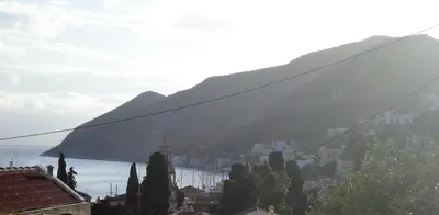 a view of a city with a mountain in the background at Eos Studios in Symi