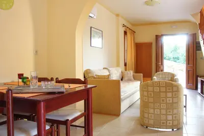 a living room with a table and a couch at Eos Studios in Symi
