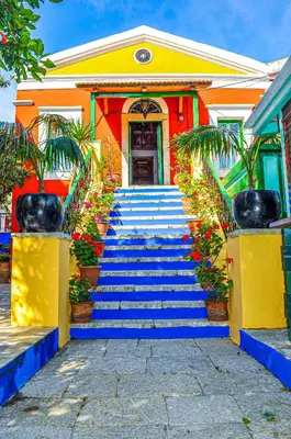 a staircase leading up to a house with flowers at Symi Garden Studios in Symi