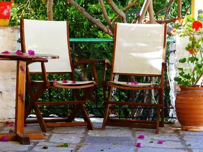 two chairs and a table with paint on them at Symi Garden Studios in Symi